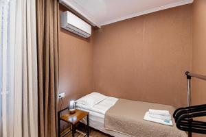a small room with a bed and a window at Apartment on Borbalo 16 in Tbilisi City