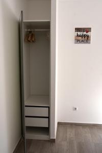 a walk in closet with a refrigerator with a happy privacy sign at Over the Beach in Monte Gordo