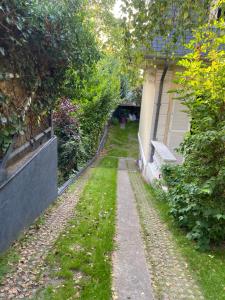 un camino de jardín junto a una casa en Appartement en souplex, en Rueil-Malmaison