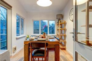 a kitchen with a table and chairs and windows at The Oxford Meadows in Oxford