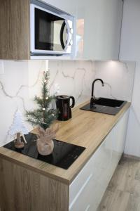 a kitchen counter with a christmas tree on it at Hellene Snow Starý Smokovec in Vysoke Tatry - Stary Smokovec