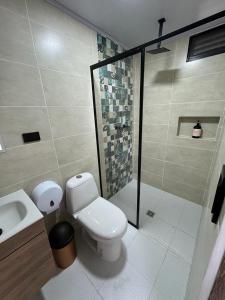 a bathroom with a toilet and a shower and a sink at SIETE COLORES in Chachagüí