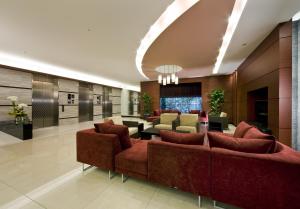 a lobby with couches and tables in a building at Daiwa Roynet Hotel Sakai Higashi in Sakai