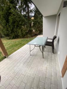 a table and a bench sitting on a patio at Ferienwohnung Simon in Bad Tatzmannsdorf