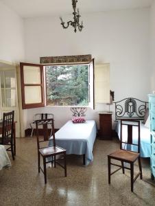 a room with a table and chairs and a window at La Villa di Minerva in Agrigento
