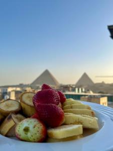a plate of fruit on top of a table at Pyramids Pride Inn in Cairo