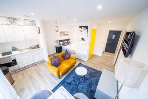 an overhead view of a living room with a yellow couch at Prime Serviced Apartments Sheffield Center in Sheffield