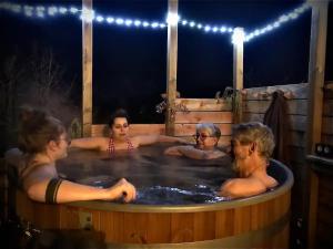 a group of people in a hot tub at night at La Marc'quize in Mouxy