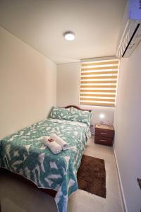 a small bedroom with a bed and a window at Apartamentos Amoblados Confort Turismo en Cúcuta 1 in Cúcuta +71 photos