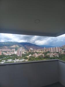 a view of a city from a window at Apartamento en Edificio Puerto paraiso en Bello Antioquia in Bello