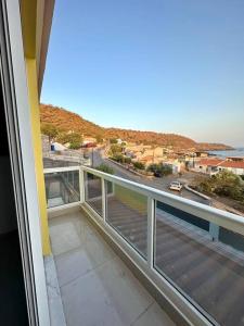 a balcony with a view of a street and the ocean at Cidade Velha - Cathedral and Sea view - 1Bdr Apart - 2 in Cidade Velha