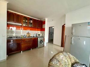 a kitchen with a stainless steel refrigerator and a dishwasher at Cidade Velha - Cathedral and Sea view - 1Bdr Apart - 2 in Cidade Velha