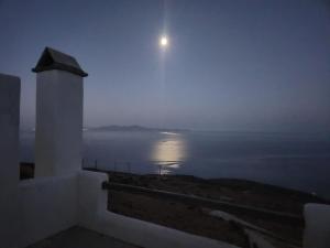 a view of the moon over the ocean at night at Sunflower Tinos House in Istérnia +41 photos