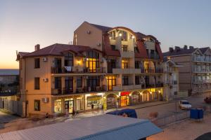 a large building with lights on in a city at Na Chernomorskoy Hotel in Feodosia