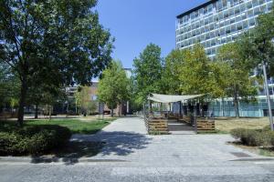 a tent in a park in front of a building at Sebenico 10 in Milan