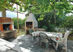 a table and chairs with a table and a fireplace at CASA CECILIA in Marina di Campo
