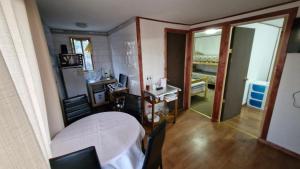 a room with a table and a room with a bedroom at Cabaña Recreo frente al mar in Viña del Mar