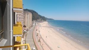 a view of a beach and the ocean at don federico tome in Tomé