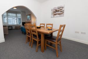 a dining room with a wooden table and chairs at Hampton House in Stockton-on-Tees