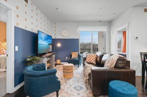 a living room with a couch and two chairs and a tv at NEW Great Escape 404 2BR Condo Near Downtown and Bay in Traverse City +60 photos