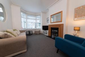 a living room with a couch and a fireplace at Hampton House in Stockton-on-Tees