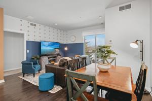 a dining room and living room with a table and a couch at NEW Great Escape 404 2BR Condo Near Downtown and Bay in Traverse City