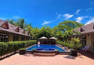 a swimming pool in front of a house at Hello Kampot Resort in Kampot