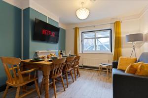 a living room with a dining room table and chairs at Sally’s Cottage - Uttoxeter: Close to Alton Towers in Uttoxeter