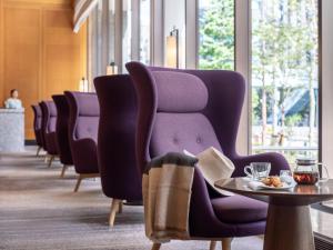 a row of chairs in a waiting room with a table at Hotel The Celestine Tokyo Shiba in Tokyo