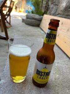 a bottle of beer next to a glass of beer at Olive Ranch Guest House in Bergas