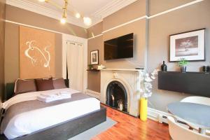a bedroom with a bed and a fireplace with a tv at The West Village Gem in New York