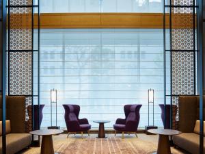 a lobby with chairs and tables and a large window at Hotel The Celestine Tokyo Shiba in Tokyo