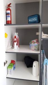 a shelf in a toy kitchen with items on it at Gorgeous Self Catering Cottage off Umhlanga Rocks in Durban