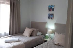 a small bedroom with a bed and a window at Gorgeous Self Catering Cottage off Umhlanga Rocks in Durban
