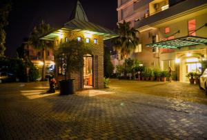 a building on a street at night at Belkon Hotel in Belek