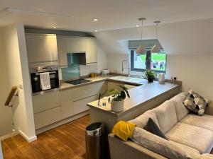 a living room with a couch and a kitchen at Flat in Budleigh Salterton in Budleigh Salterton