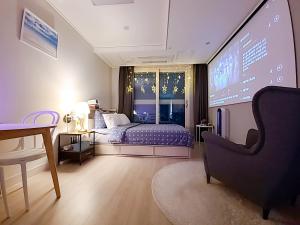 a bedroom with a bed and a projection screen at Secret-고층호수공원뷰,나만의영화관,미사역2분,120인치스크린,넷플,디즈니플러스,장기숙박추천 in Hanam