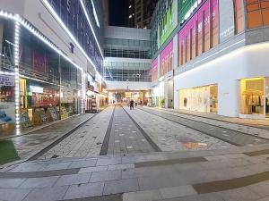 an empty street in a shopping mall at night at Secret-고층호수공원뷰,나만의영화관,미사역2분,120인치스크린,넷플,디즈니플러스,장기숙박추천 in Hanam
