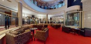 a lobby with chairs and tables in a building at Derby Mickleover Hotel, BW Signature Collection in Derby