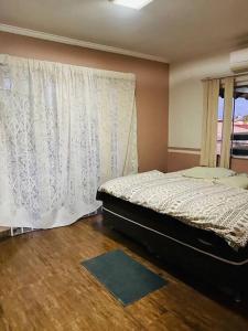 a bedroom with a bed and a window at Sobrado Apartamento de Praia in Pontal do Paraná