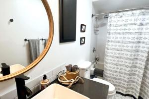 a bathroom with a mirror and a sink and a toilet at OSU Retro Cottage Retreat in PNW in Corvallis