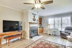 a living room with a fireplace and a tv at Modern McCormick Townhome on Lake Thurmond! in McCormick
