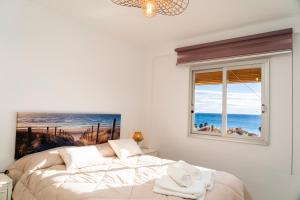 biała sypialnia z łóżkiem i oknem w obiekcie SEE THE SEA w mieście Villajoyosa