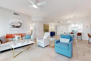 a living room with a couch and a table at Portofino Paradise in Pensacola Beach