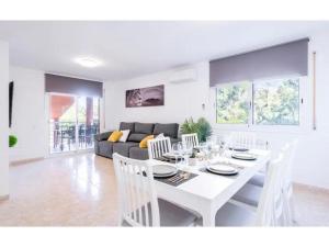 a white dining room with a white table and chairs at Villa Mora 2 Pool Oasis in La Mora