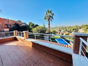 a balcony with a view of a palm tree at Villa Mora 2 Pool Oasis in La Mora