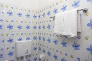 a bathroom with blue flowers on the wall at Hotel White House International (Near Dhaka Medical) in Dhaka