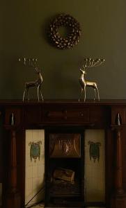 a wooden table with two deer statues on top of it at Oakhurst Guesthouse in Cobh