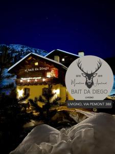a building with a sign with a deer on it at Bait da Diego in Livigno
