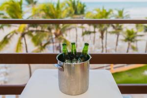 a bucket of beer bottles sitting on a table at G2 Beach Hotel in Aquiraz